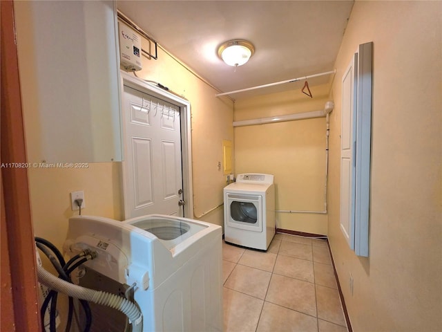 laundry room featuring light tile patterned floors and washer and clothes dryer