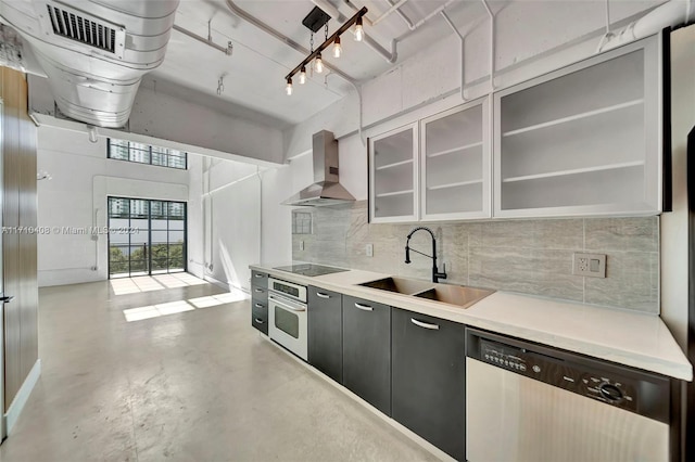 kitchen with dishwasher, wall chimney exhaust hood, sink, oven, and black electric cooktop