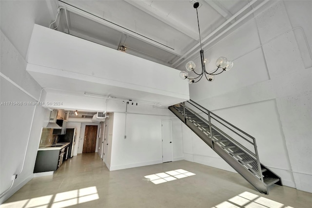 unfurnished living room with sink and a notable chandelier