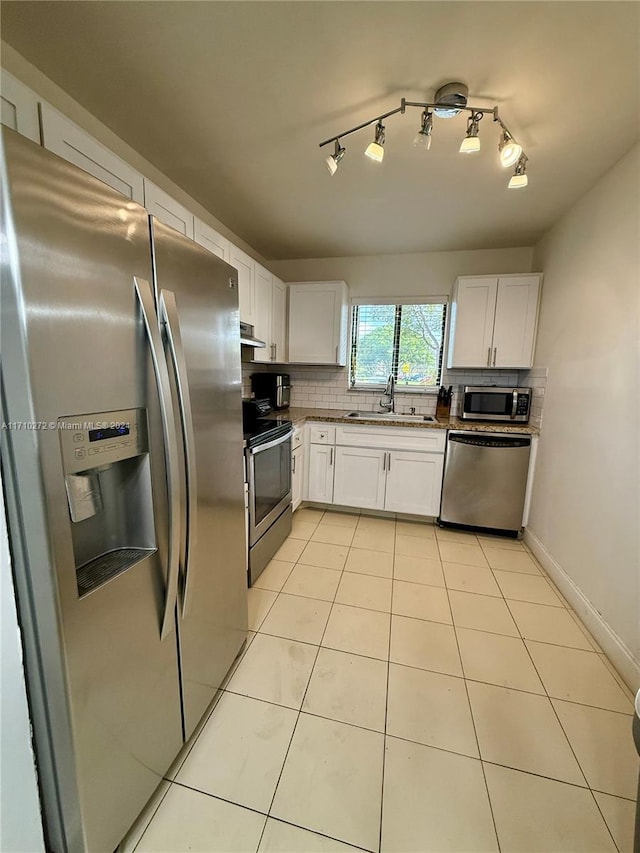 kitchen with white cabinets, backsplash, stainless steel appliances, and sink