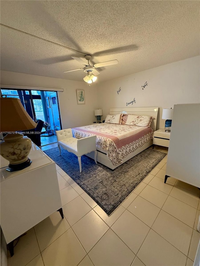 tiled bedroom featuring ceiling fan, access to exterior, and a textured ceiling