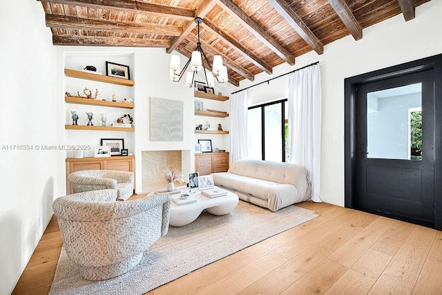 living room featuring beam ceiling, high vaulted ceiling, wooden ceiling, a notable chandelier, and light hardwood / wood-style floors