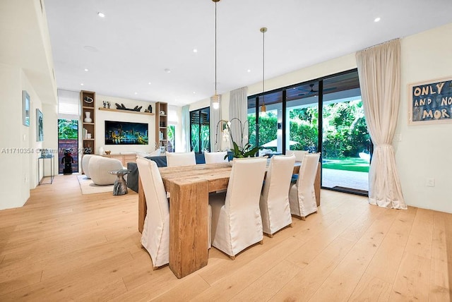 dining space featuring built in shelves and light wood-type flooring