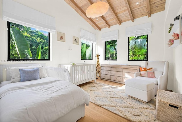 bedroom with beamed ceiling, light hardwood / wood-style floors, high vaulted ceiling, and wood ceiling