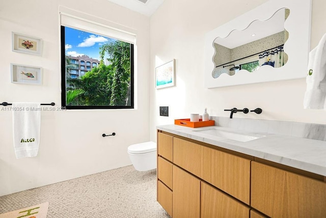 bathroom with tile patterned floors, vanity, and toilet