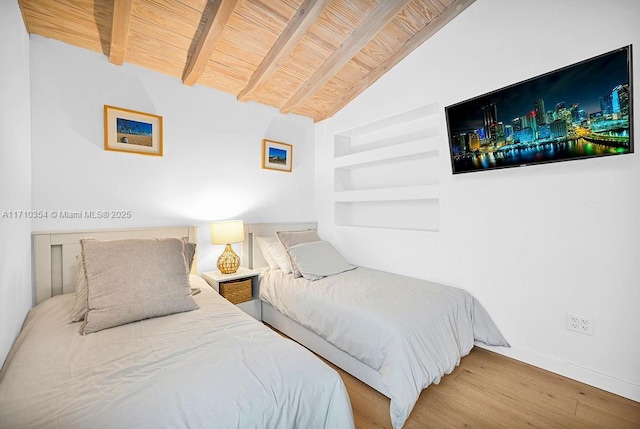 bedroom with vaulted ceiling with beams, wood ceiling, and hardwood / wood-style flooring