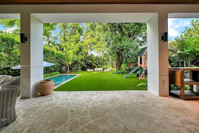 exterior space with a playground and a yard