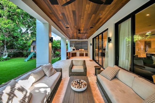 view of patio with a playground, an outdoor kitchen, ceiling fan, and an outdoor hangout area