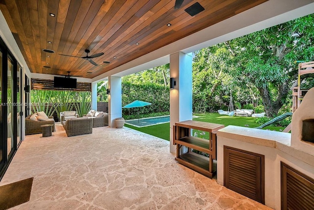 view of patio with outdoor lounge area and ceiling fan