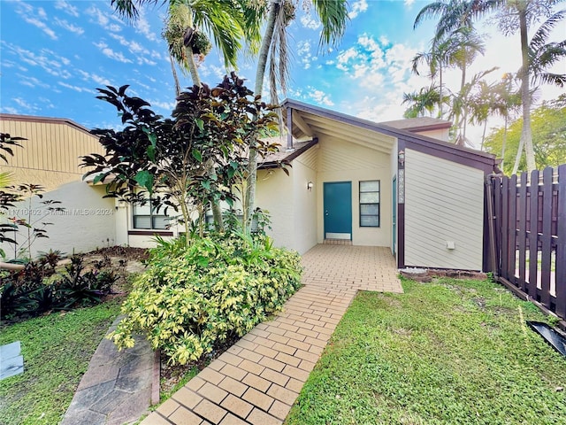 rear view of property with a lawn