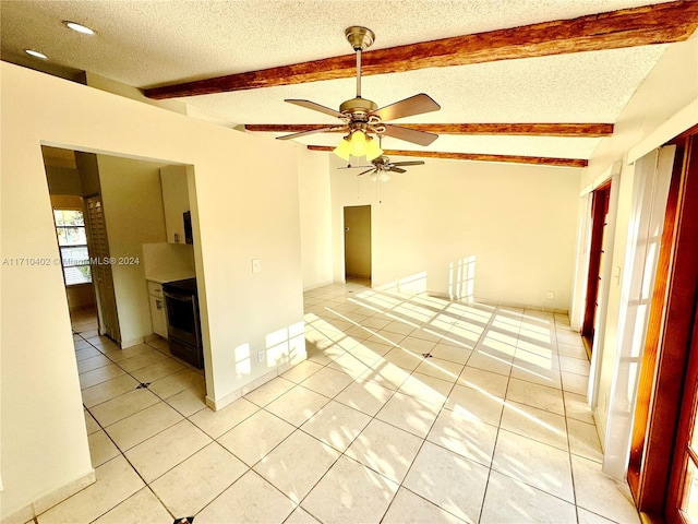 tiled spare room with vaulted ceiling with beams, a textured ceiling, and ceiling fan