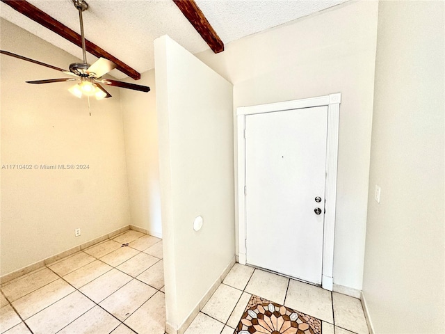 entrance foyer featuring a textured ceiling, vaulted ceiling with beams, ceiling fan, and light tile patterned flooring