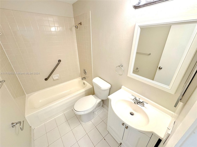 full bathroom featuring tile patterned flooring, vanity, tiled shower / bath combo, and toilet