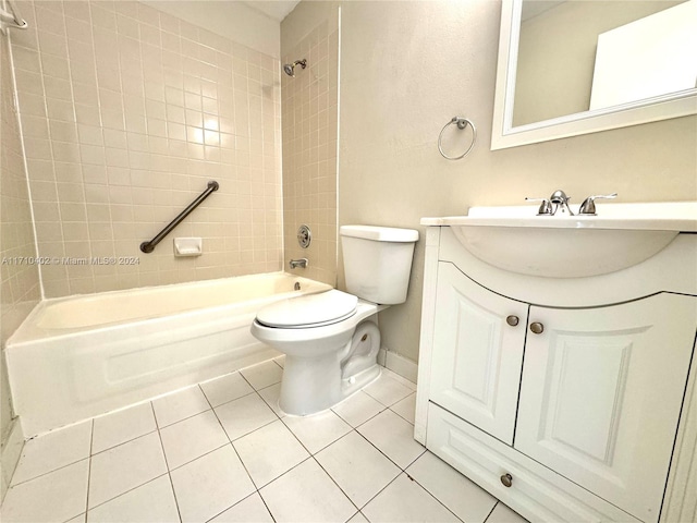 full bathroom with tile patterned floors, vanity, tiled shower / bath, and toilet