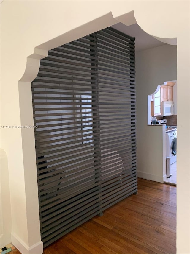 interior details with washer / clothes dryer and hardwood / wood-style flooring