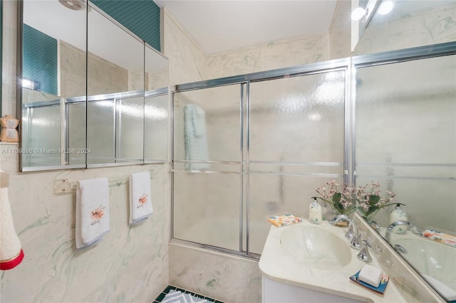 bathroom featuring vanity and combined bath / shower with glass door