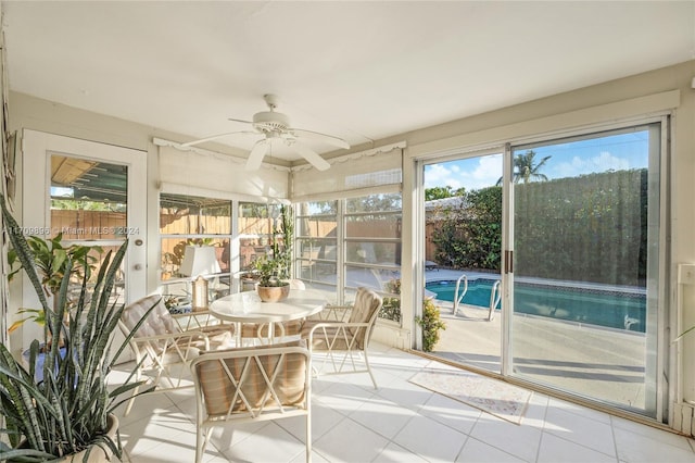 unfurnished sunroom with ceiling fan