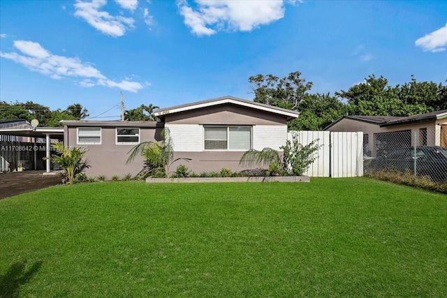 view of property exterior with fence, a lawn, and stucco siding