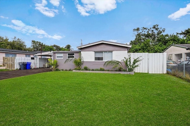 view of front of home with a front yard and a carport