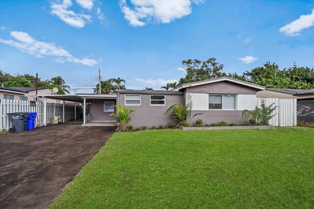 view of front facade with a carport and a front lawn