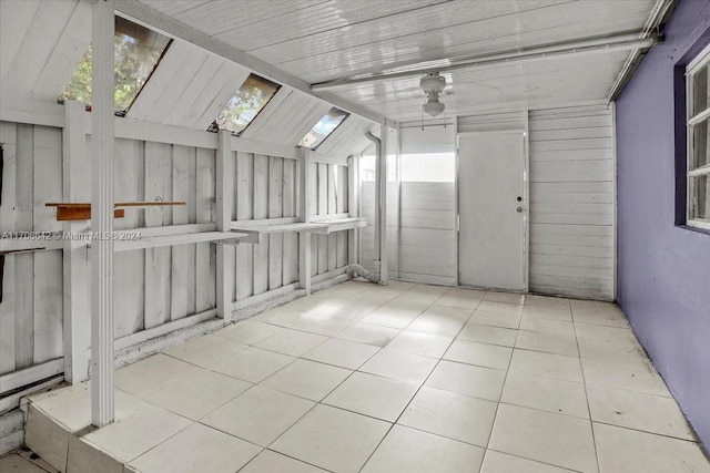 interior space featuring vaulted ceiling with skylight