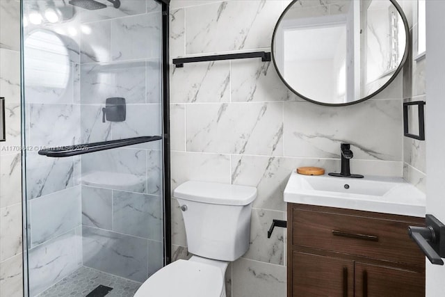 bathroom featuring toilet, a shower stall, and vanity