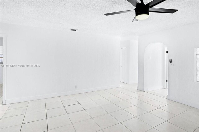 unfurnished living room featuring light tile patterned floors, a textured ceiling, and ceiling fan