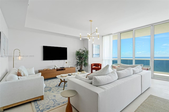 living room with an inviting chandelier and a wall of windows