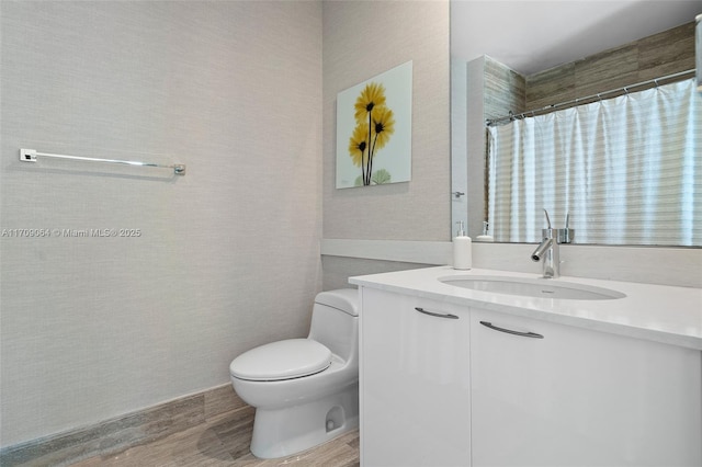 bathroom featuring vanity, wood-type flooring, walk in shower, and toilet