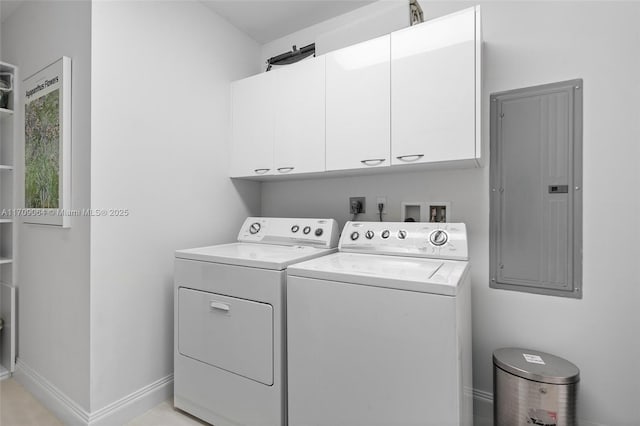 laundry room featuring independent washer and dryer, electric panel, and cabinets