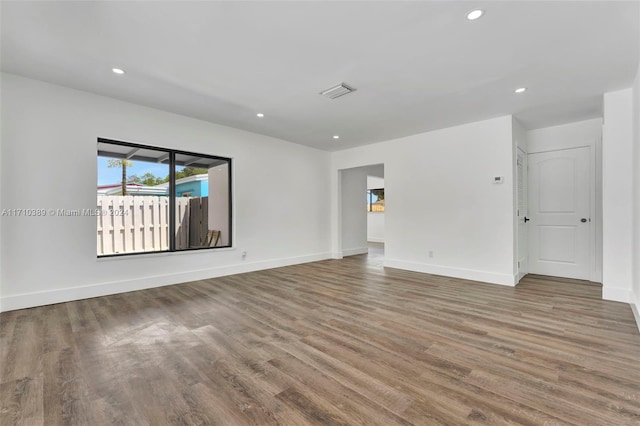 spare room with wood-type flooring