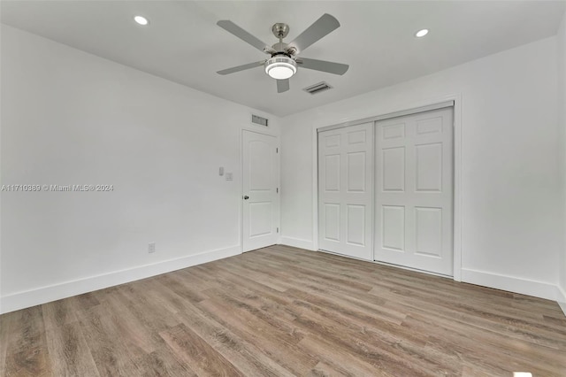 unfurnished bedroom with a closet, light hardwood / wood-style floors, and ceiling fan