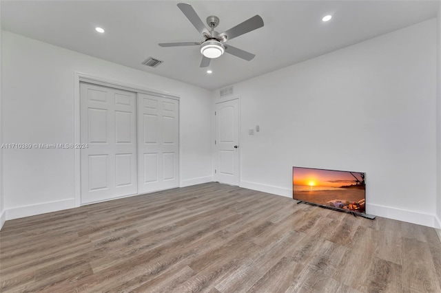 unfurnished bedroom with a closet, ceiling fan, and light hardwood / wood-style flooring