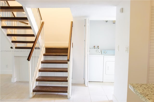 staircase featuring tile patterned floors and washing machine and clothes dryer