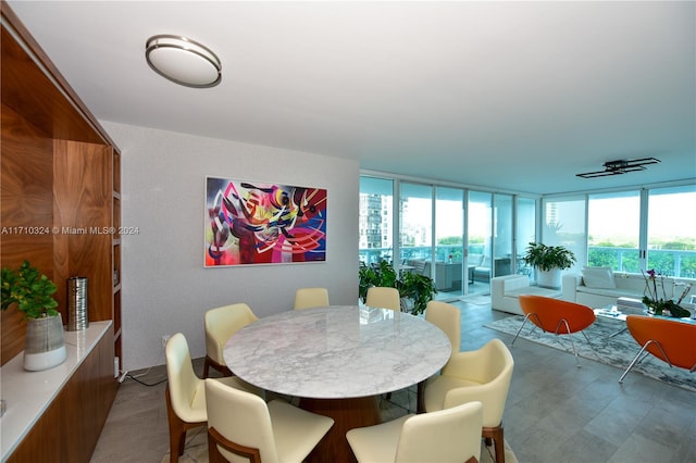 dining area featuring floor to ceiling windows and ceiling fan