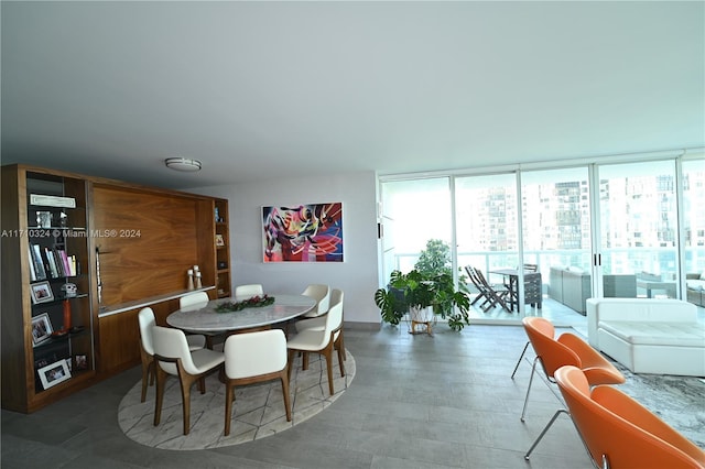 dining area featuring floor to ceiling windows and a healthy amount of sunlight