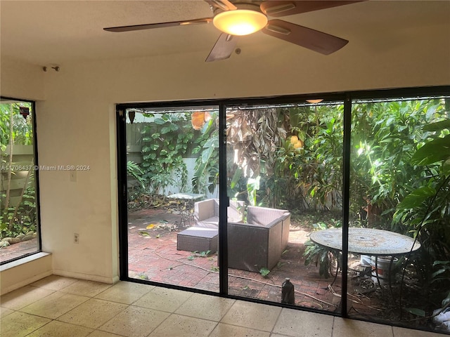 unfurnished sunroom featuring ceiling fan