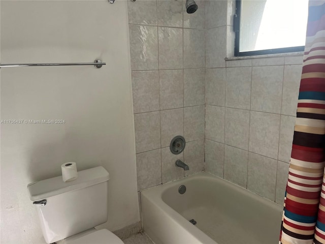 bathroom with toilet and shower / bath combo with shower curtain