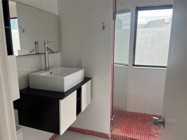 bathroom featuring tile patterned floors, vanity, and an enclosed shower