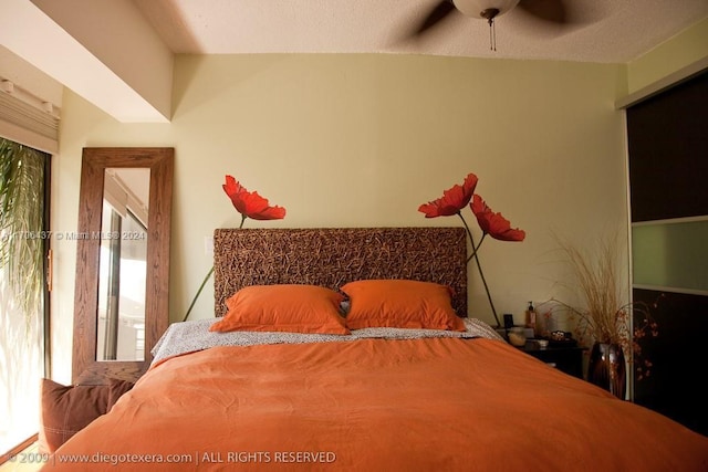 bedroom featuring ceiling fan and multiple windows