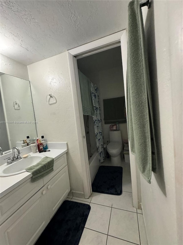 full bathroom with tile patterned flooring, vanity, toilet, shower / bath combo, and a textured ceiling