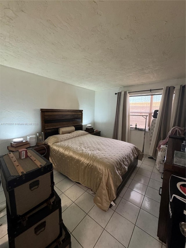 tiled bedroom featuring a textured ceiling