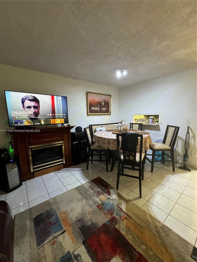 dining space with light tile patterned flooring and a textured ceiling