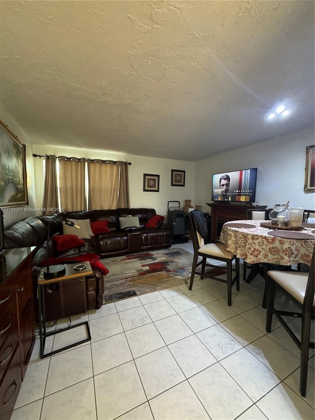 tiled living room featuring a textured ceiling