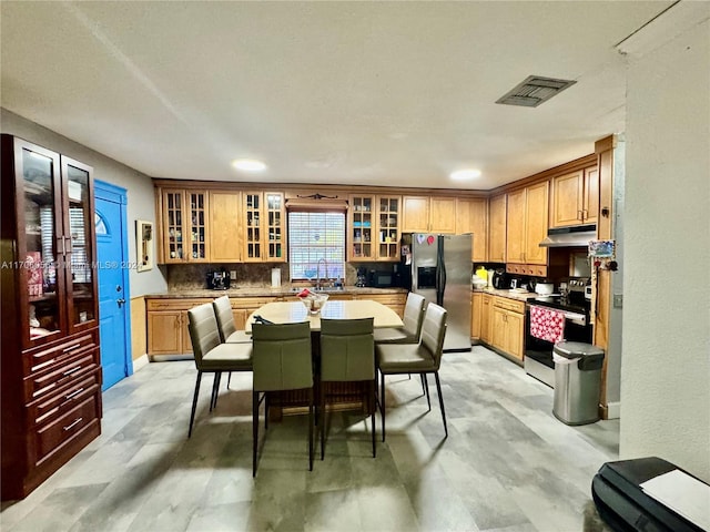 kitchen with decorative backsplash, sink, and stainless steel appliances