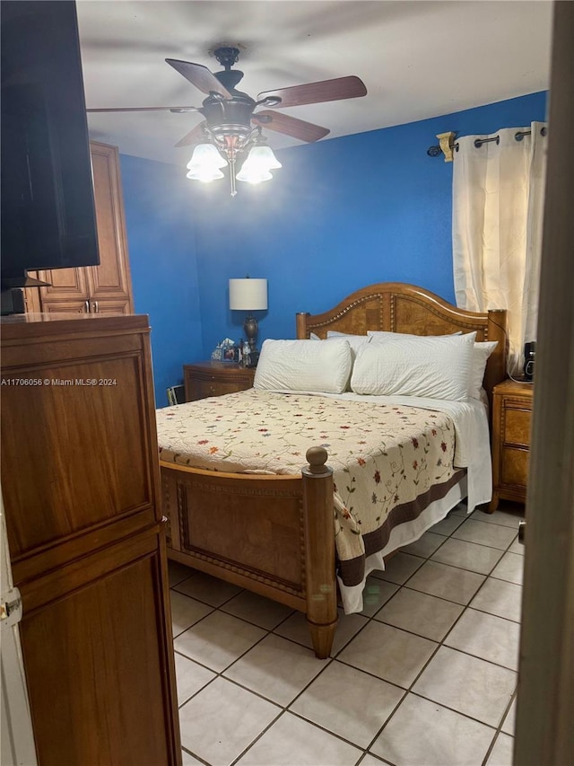 tiled bedroom featuring ceiling fan