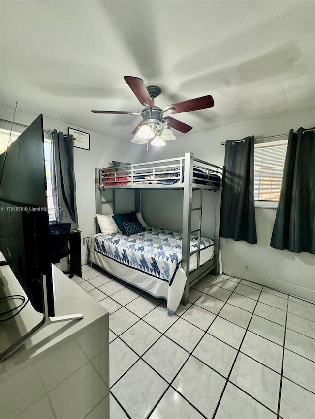 tiled bedroom featuring ceiling fan