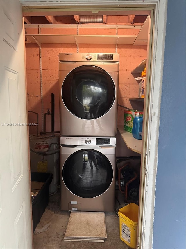 clothes washing area with stacked washer and clothes dryer