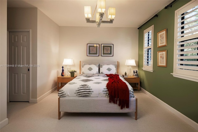 bedroom featuring multiple windows, a chandelier, and light carpet