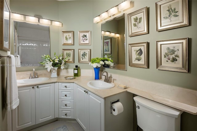 bathroom with toilet, tile patterned floors, and vanity